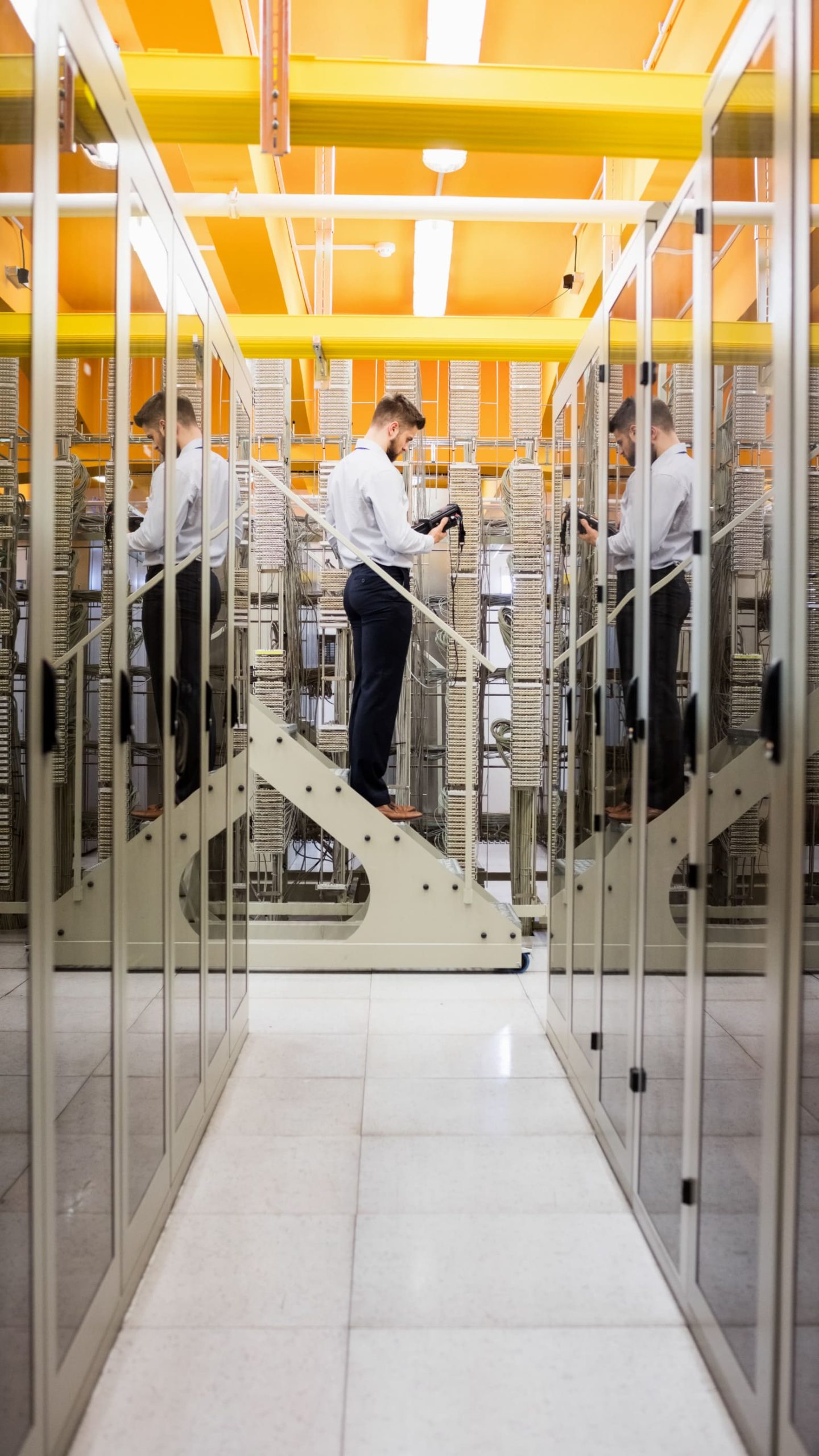 Worker maintaining equipment inside modern data facility